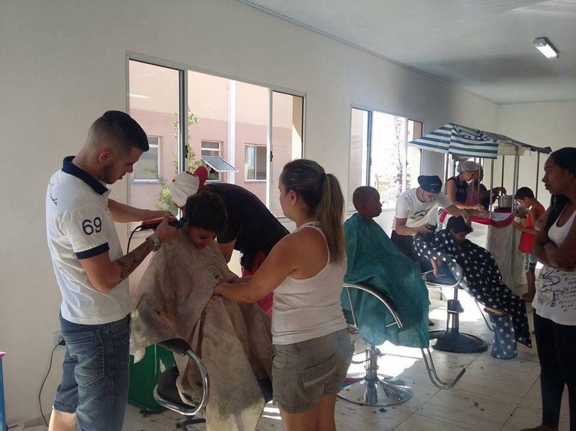 Ação social de corte de cabelo — voluntários cortando cabelo de crianças